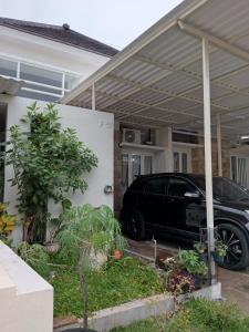 a car parked under a pergola in a house at VIKA Villa Kayana Kota Batu in Karangploso