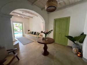 salon ze stołem i zielonymi drzwiami w obiekcie Zen House w mieście Ahangama