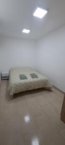 a bed sitting on top of a tile floor at Villa Verde Pet-friendly in Córdoba +13 photos