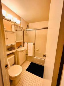 a small bathroom with a toilet and a shower at 1-Bed Urban Oasis Prime Location in Arlington