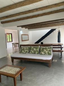 a living room with a couch and a table at Casa Flor da Terra in Caraíva
