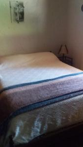 a bed in a small room with at ANAHATA in Barra del Chuy