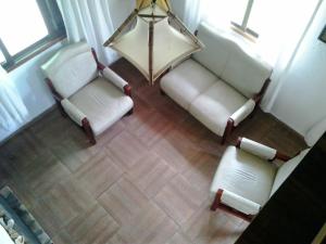 an overhead view of a living room with two white chairs at ANAHATA in Barra del Chuy