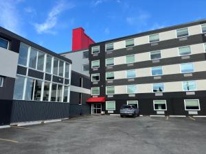 a car parked in a parking lot next to a building at Superior Shores Hotel, BW Signature Collection by Best Western in Thunder Bay