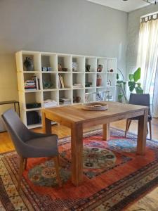 a wooden table and chairs in a living room at Beach Street Loft in Boston