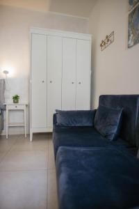 a living room with a blue couch and a white cabinet at Tra Lago Maggiore e lago d'Orta Appartamento ACQUA in Colazza +85 photos