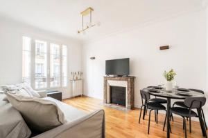 a living room with a table and a fireplace at The Square, Paris-Asnières, Private Apartment with Bedroom and Living Room in Asnières-sur-Seine