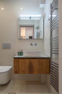 a bathroom with a sink and a mirror at Seaside Apartment in Salamís