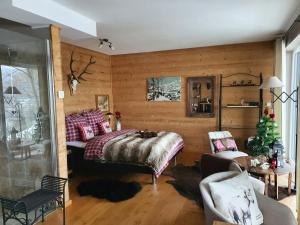 a bedroom with a bed in a wooden wall at River Mosel Holiday Homes/Delux studio Meerfeld with a lake view in Meerfeld