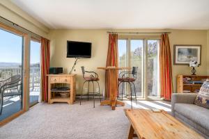 a living room with a couch and a tv at Fantastic Steamboat Location With Amazing Views in Steamboat Springs