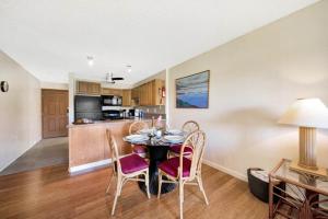 a kitchen and dining room with a table and chairs at Kauai Banyan Harbor B24 condo in Lihue