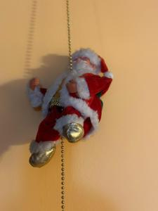 a santa claus toy hanging from a ceiling at Il Regno Dei Vacanzieri in Pescocostanzo