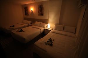 Voodi või voodid majutusasutuse Pyramids Heart Hotel toas