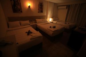 Voodi või voodid majutusasutuse Pyramids Heart Hotel toas