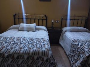 a bedroom with two beds and a pillow on it at Bellas Vistas in Riópar