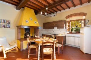 a kitchen with a table and a large oven at Agriturismo Bellosguardo in Reggello