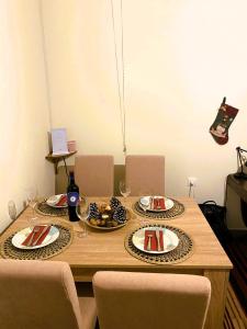 a wooden table with plates of food and wine glasses at Methydrion Country House in Vitina