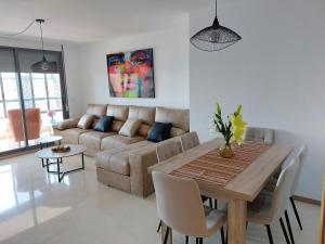 - un salon avec une table et un canapé dans l'établissement Las Marinas 8o con Vistas al Mar y Piscina by Vero, à Benidorm