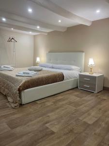 a bedroom with a large bed and a wooden floor at E&G House in Naples
