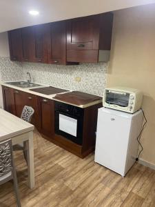 a kitchen with a microwave on top of a refrigerator at E&G House in Naples