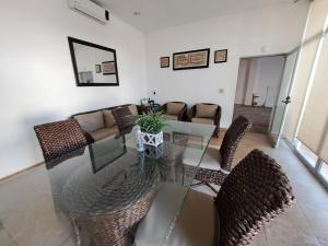 sala de estar con mesa de cristal y sillas en Casa Privada San Blas, en San Blas