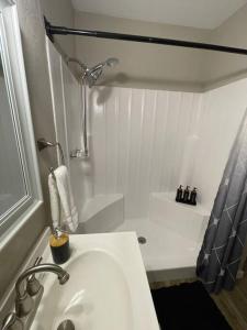 a white bathroom with a sink and a shower at New Stylish Midtown With One Bedroom (Unit D) in Phoenix