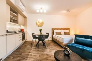 a living room with a bed and a table at Apartman Mikulov Garden in Mikulov