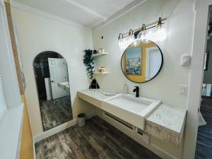 a bathroom with a sink and a mirror at Woody Mountain Bed & Breakfast in Flagstaff