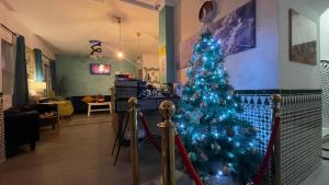 a blue christmas tree in a living room at Hotel Boutique Andalucia in Fuengirola