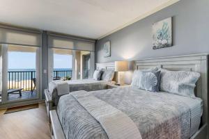 Oceanfront Elegance at AIP Resort في أميليا أيلاند: غرفة نوم بسريرين وشرفة