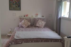 a bedroom with a bed with pillows and a window at ty-yan in Tours
