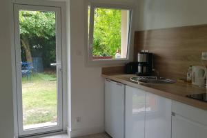 a kitchen with a counter with a sink and a window at ty-yan in Tours