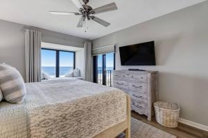 a bedroom with a bed and a flat screen tv at LUX Oceanfront Retreat at AIPResort in Amelia Island