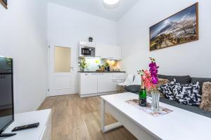 a living room with a couch and a table at Stylish Apartment at Wenceslas Square in Prague