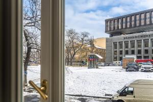 a view of a snow covered street from a window at Stylish Apartment at Wenceslas Square in Prague