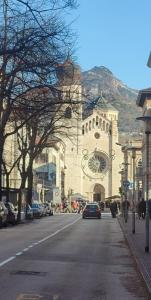 a car driving down a street in front of a building at Verdisuite - Trento centro - Parcheggio privato gratuito in Trento