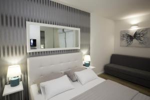 a bedroom with a white bed and a black couch at Holiday Home EB with Heated Pool in Gata +37 photos