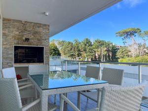 un patio con mesa, sillas y chimenea en Emerald Apartments - Parrillero exclusivo en Punta del Este