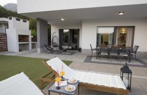 a patio with a white couch and a table at Holiday Home EB with Heated Pool in Gata