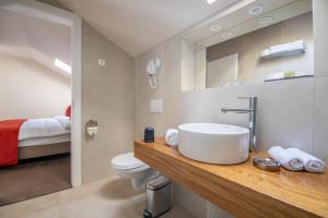 a bathroom with a sink and a toilet at PENSIUNEA GAMBRINUS **** in Miercurea-Ciuc