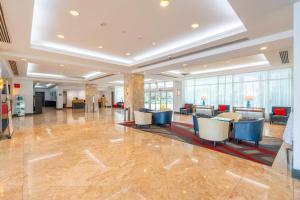 a lobby with chairs and tables in a building at Luxury Condo Hotel with full kitchen, located at 5 mints walk to the beach in Fort Lauderdale