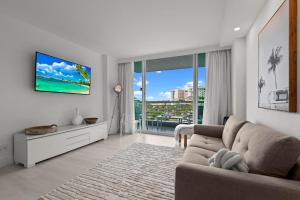 a living room with a couch and a large window at Luxury Condo Hotel with full kitchen, located at 5 mints walk to the beach in Fort Lauderdale