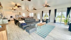 a living room with a couch and a table at Eleuthera Retreat - Villa & Cottages on pink sand beachfront in North Palmetto Point