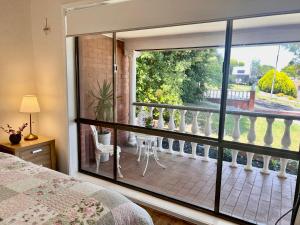 a bedroom with a view of a balcony at Cozy and nice stay with sunset view! in Mooroolbark
