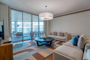 a living room with a couch and a table at Suite 107 - Two bedroom apartment in Funchal