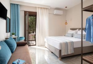 a bedroom with a bed and a couch at VagAthan - Lux Holidays in Afitos