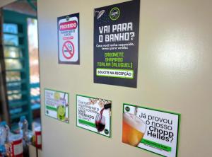 a bunch of signs on a wall in a store at Casa do Rogério Hostel in Caxias do Sul