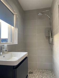 a bathroom with a sink and a shower at House in Mid Ulster - Sleeps 8 in Draperstown