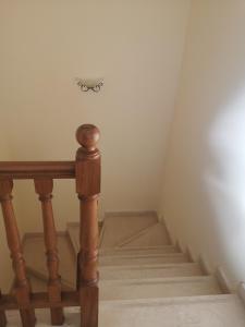 a flight of stairs with a wooden rail and a small drawer at Apartment Mar à Vista in Portimão