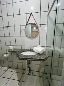 a bathroom with a sink and a mirror at Pousada Riosmar in Balneário Camboriú